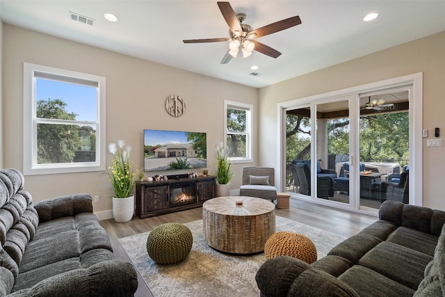 living room with hardwood / wood-style floors and ceiling fan