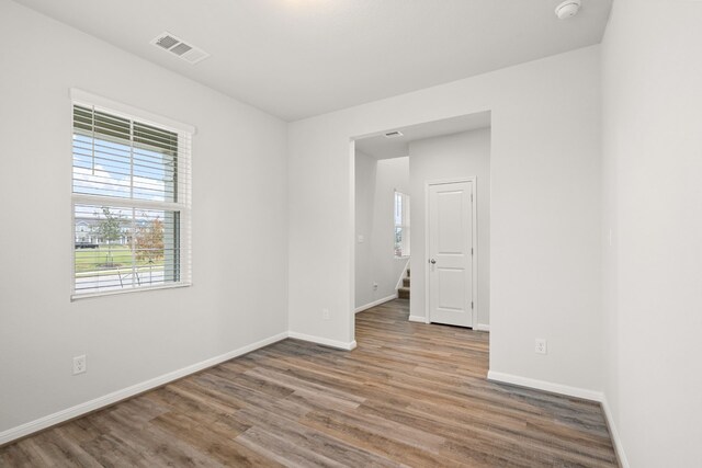 spare room featuring wood-type flooring