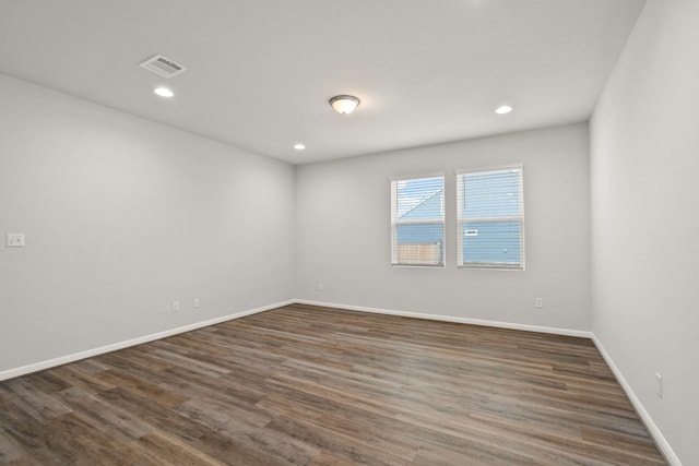 spare room featuring dark hardwood / wood-style flooring