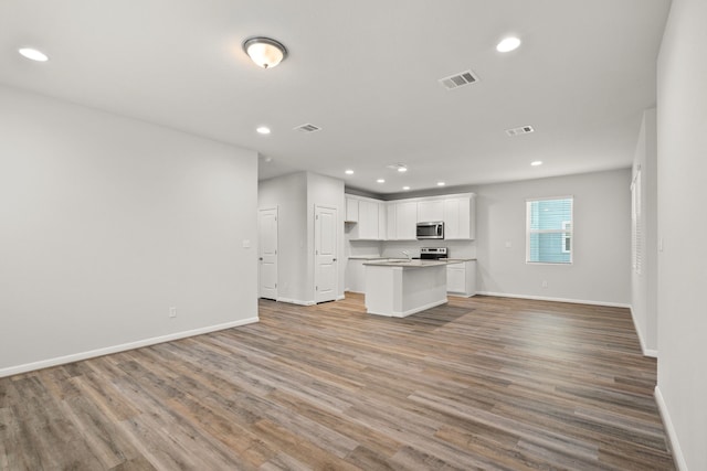 unfurnished living room featuring light wood-type flooring and sink