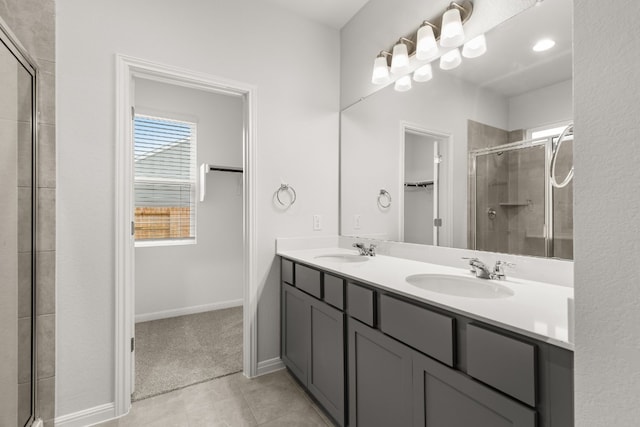 bathroom featuring an enclosed shower, vanity, and tile patterned floors