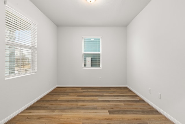 unfurnished room featuring hardwood / wood-style floors and a wealth of natural light