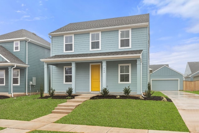 front of property with an outbuilding, a garage, covered porch, and a front yard