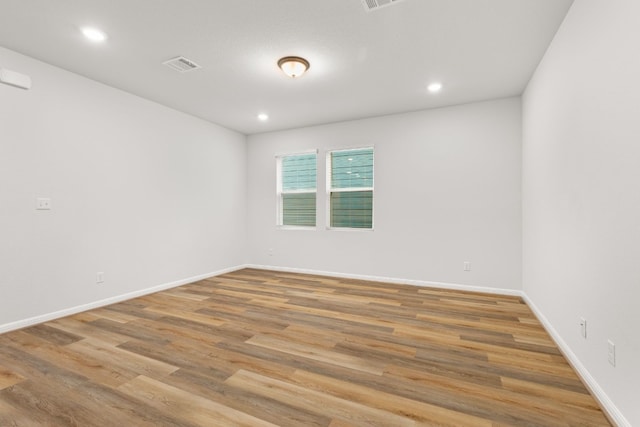 unfurnished room with wood-type flooring