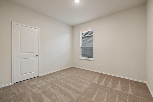 unfurnished room featuring light colored carpet