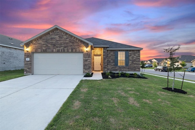 view of front of home with a garage and a yard