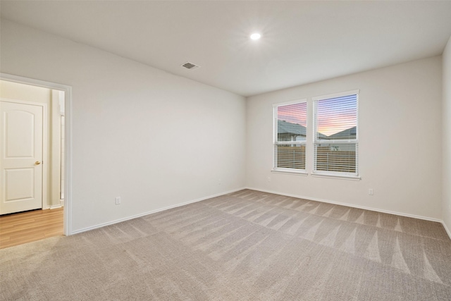 empty room featuring light colored carpet