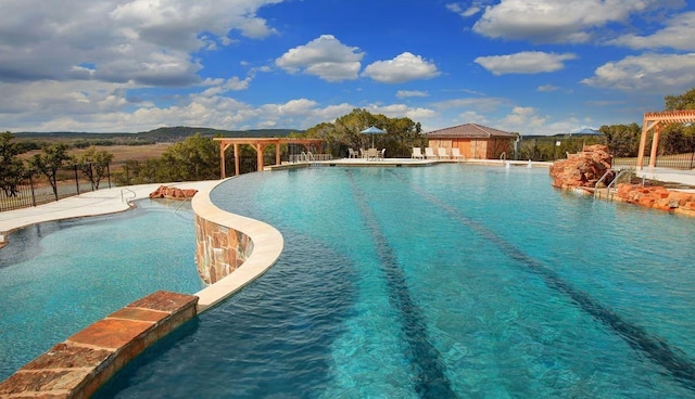 view of swimming pool with pool water feature