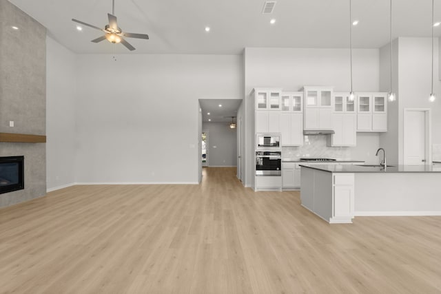 kitchen featuring white cabinets, appliances with stainless steel finishes, ceiling fan, and pendant lighting