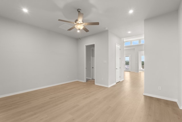 empty room featuring ceiling fan and light hardwood / wood-style flooring