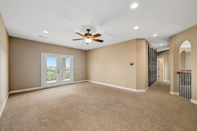 spare room with carpet floors, french doors, and ceiling fan