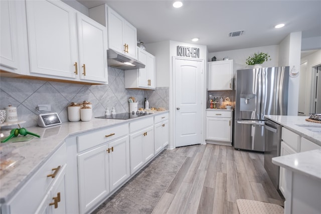 kitchen featuring light hardwood / wood-style floors, stainless steel appliances, tasteful backsplash, light stone countertops, and white cabinets