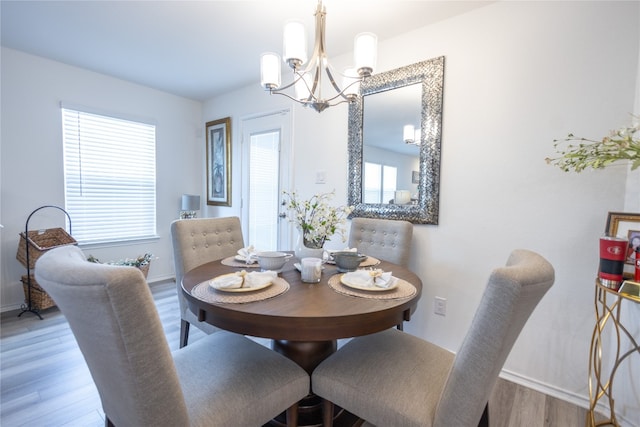 dining space featuring a notable chandelier and hardwood / wood-style flooring