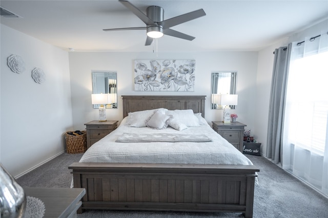 carpeted bedroom with ceiling fan and multiple windows