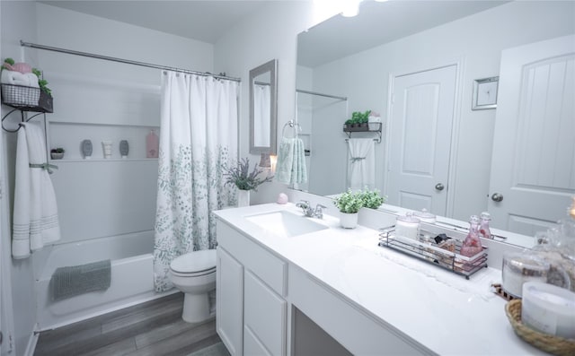 full bathroom featuring shower / bath combo, wood-type flooring, toilet, and vanity