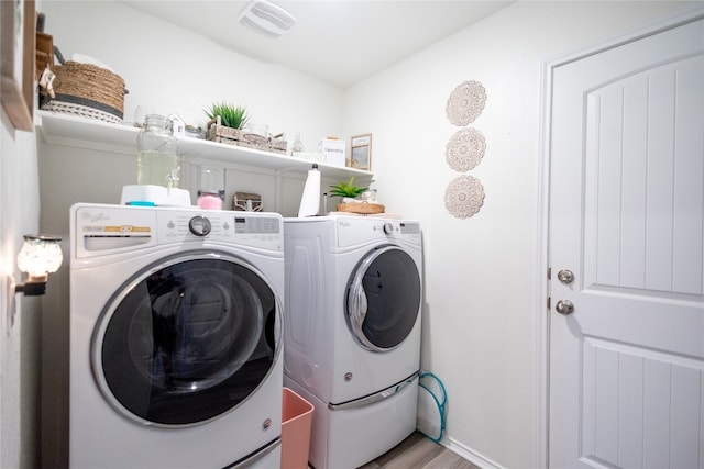 washroom featuring washer and dryer and hardwood / wood-style flooring