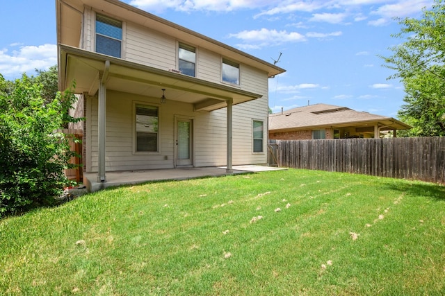 rear view of house with a patio area and a yard