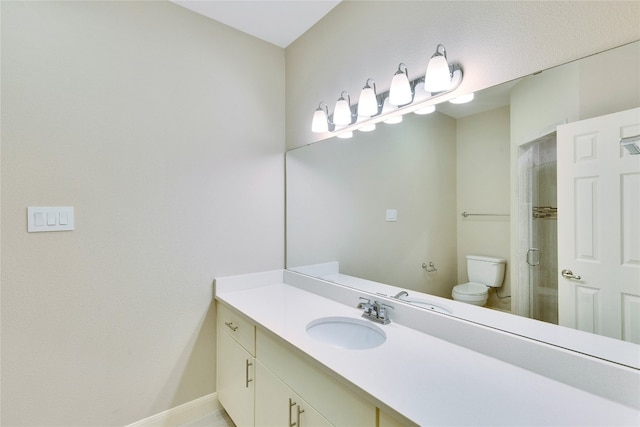 bathroom with vanity, toilet, and an enclosed shower