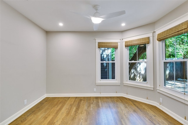 empty room with ceiling fan, light hardwood / wood-style floors, and a wealth of natural light