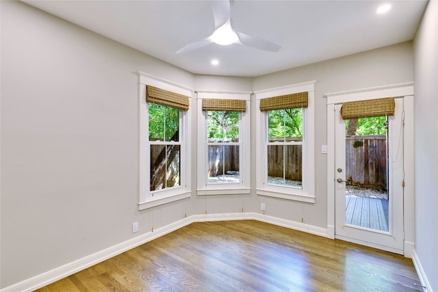 empty room with ceiling fan and hardwood / wood-style flooring