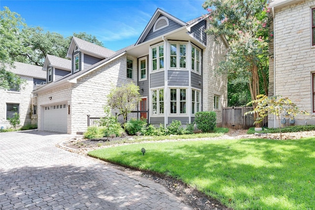 view of front of property with a garage and a front lawn