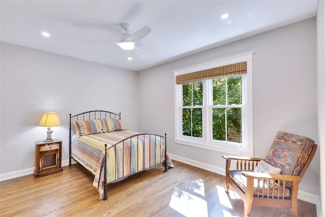 bedroom with light hardwood / wood-style floors and ceiling fan