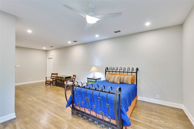 bedroom with ceiling fan and light hardwood / wood-style flooring