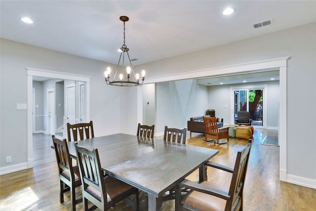 dining space featuring a notable chandelier and hardwood / wood-style flooring