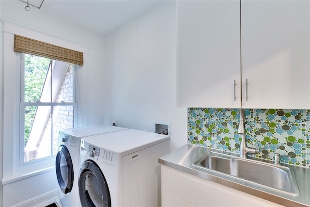 clothes washing area with cabinets, plenty of natural light, independent washer and dryer, and sink