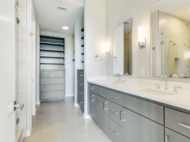 bathroom with tile patterned flooring, vanity, and an enclosed shower