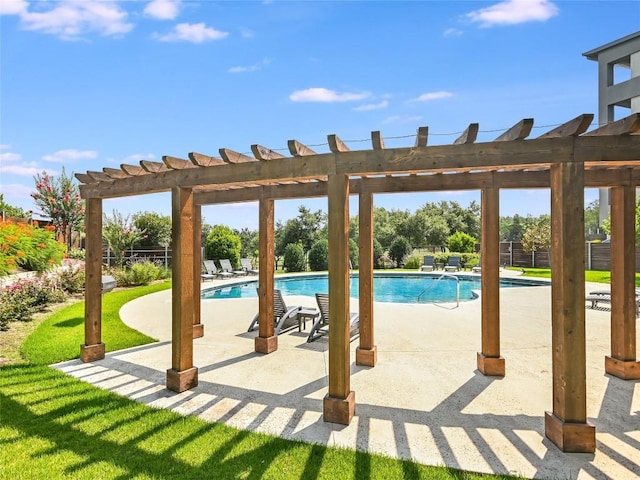 view of pool with a pergola, a patio area, and a lawn