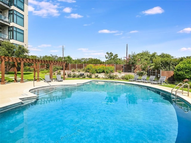 view of swimming pool featuring a patio area and a pergola