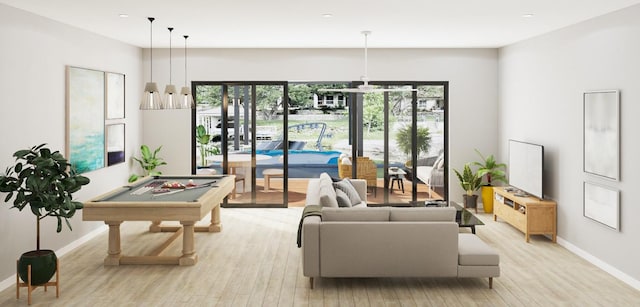 living room with pool table and light hardwood / wood-style flooring