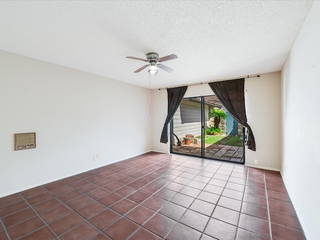 tiled empty room featuring ceiling fan and a textured ceiling