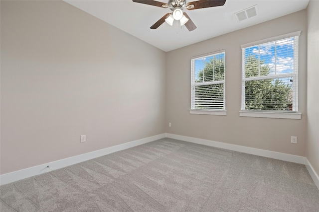 empty room featuring carpet, ceiling fan, and plenty of natural light