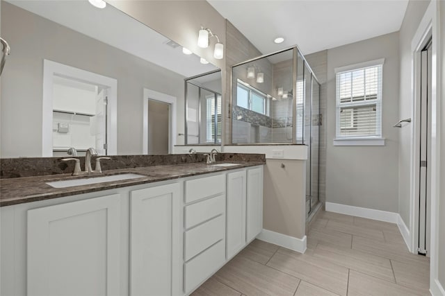 bathroom featuring double vanity, walk in shower, and tile flooring