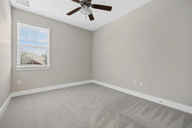 carpeted empty room featuring ceiling fan