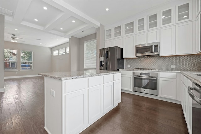 kitchen with white cabinets, dark hardwood / wood-style floors, coffered ceiling, and stainless steel appliances