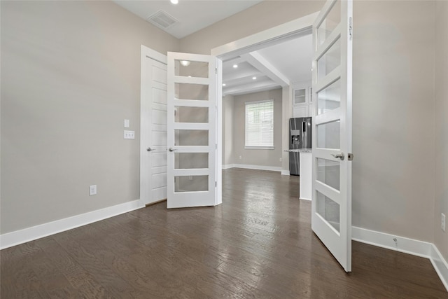 spare room with french doors and dark hardwood / wood-style floors