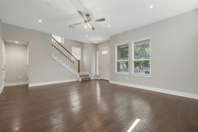 unfurnished living room featuring ceiling fan and dark hardwood / wood-style flooring