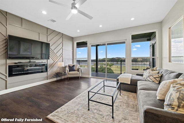 living room featuring hardwood / wood-style flooring, ceiling fan, and a healthy amount of sunlight