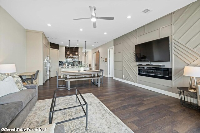 living room with dark hardwood / wood-style flooring and ceiling fan