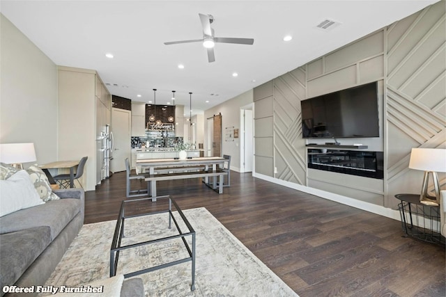 living area featuring dark wood-type flooring, recessed lighting, visible vents, and ceiling fan