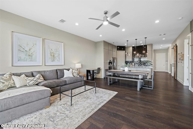 living area with ceiling fan, visible vents, dark wood-style flooring, and recessed lighting