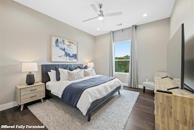 bedroom with dark wood-style flooring, visible vents, and baseboards