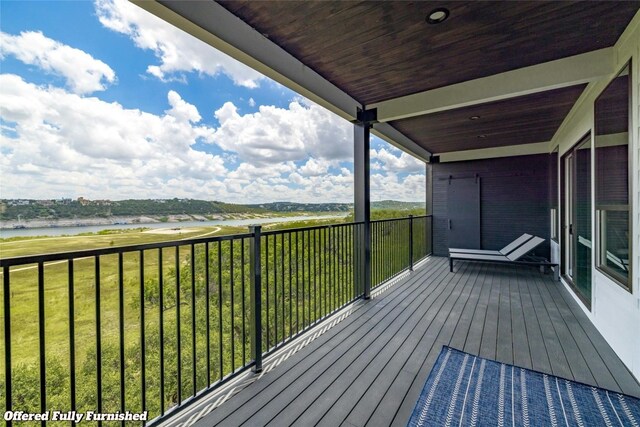 wooden deck featuring a yard and a water view