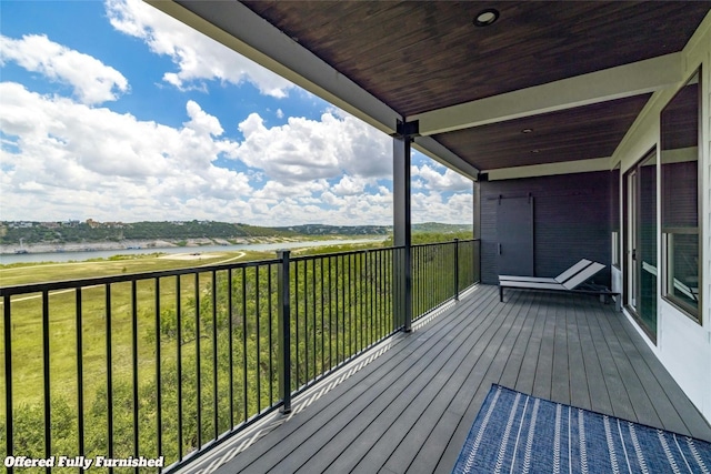 wooden terrace featuring a water view