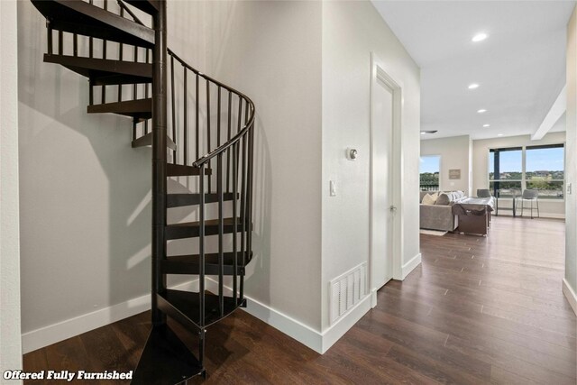 stairway with hardwood / wood-style flooring