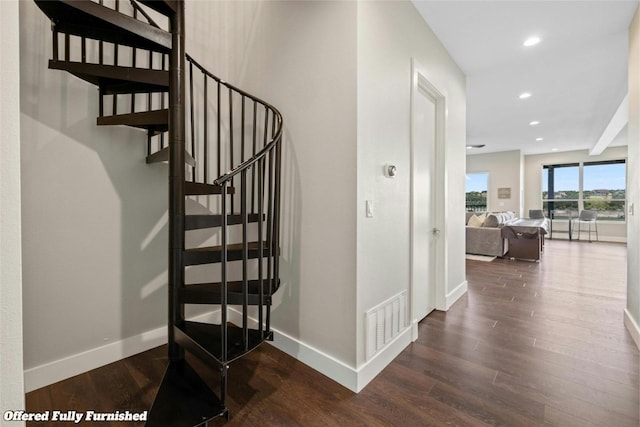 stairs with baseboards, visible vents, wood finished floors, and recessed lighting