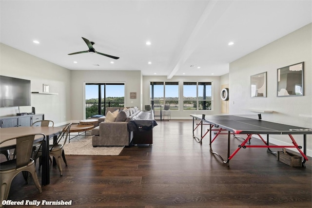 recreation room featuring beamed ceiling, dark hardwood / wood-style flooring, and ceiling fan